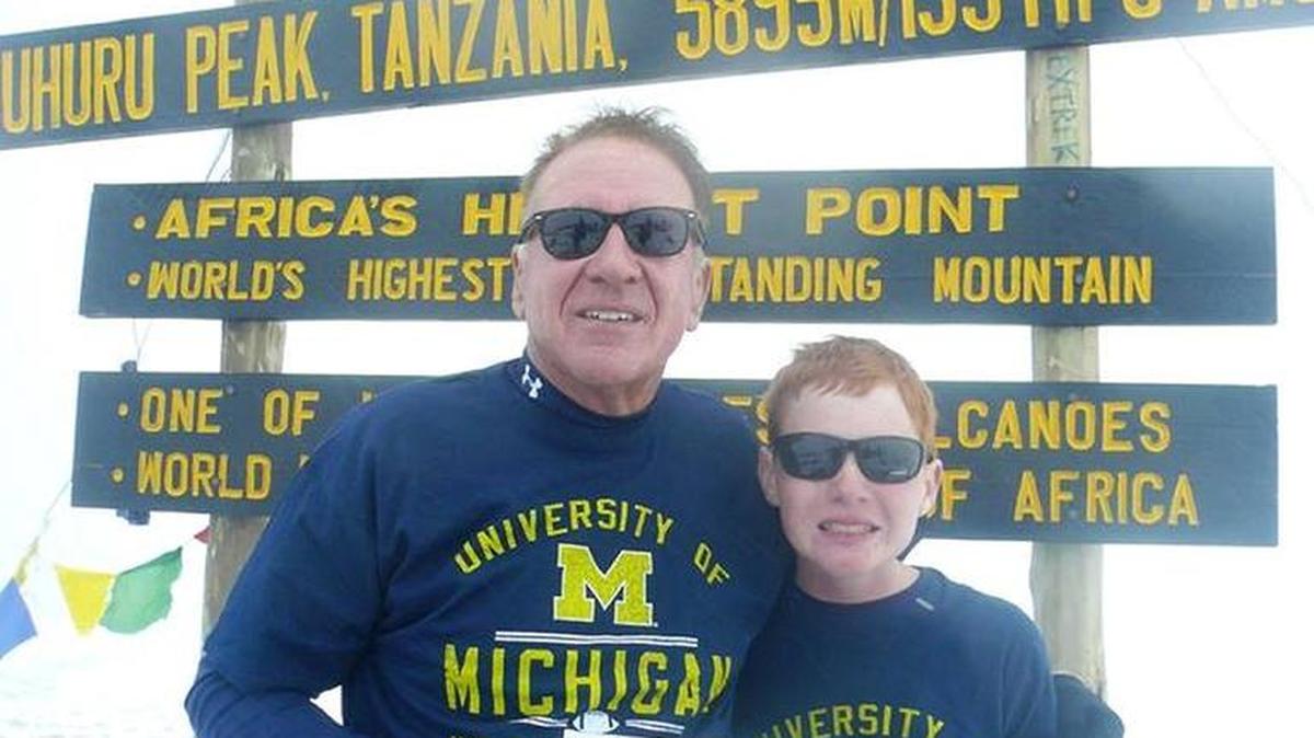 Tim Brown, who died in the crash, seen in 2015, with son, Timmy, who did not make the trip and survives the family tragedy.