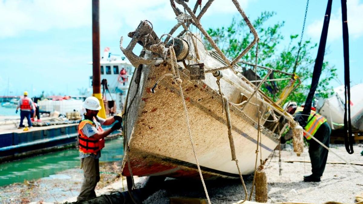 Contractors work Oct. 11 to remove a vessel displaced by Hurricane Irma at Boot Key Harbor City Marina in Marathon. Response crews from the Coast Guard, Florida Fish and Wildlife Conservation Commission and the Environmental Protection Agency are managing vessel-removal operations. More than 700 boats have been removed in the Keys.