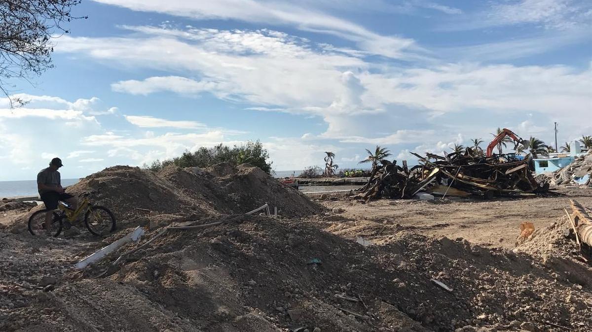 Billy Quinn sits on his mountain bike atop a pile of debris where his Sea Breeze RV and Marina home stood until it was completely destroyed by Hurricane Irma.