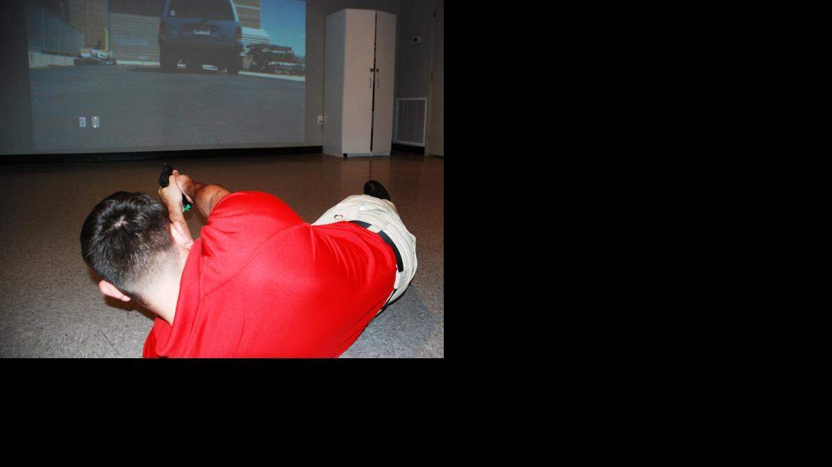 
Monroe County Corrections Deputy Tony Lopez demonstrates the training using the discretionary shooting simulator that all sworn officers at the sheriff's office go through annually.
