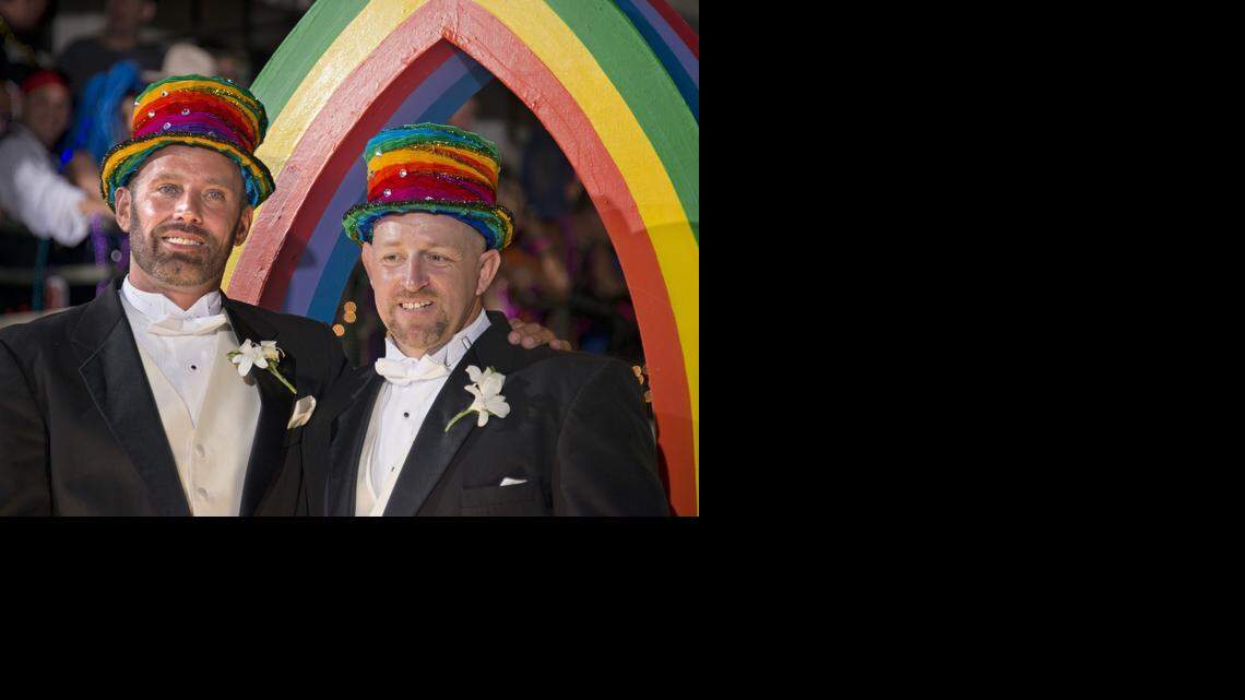 
In this Saturday, Oct. 25, 2014, photo provided by the Florida Keys New Bureau, Aaron Huntsman, left, and William Lee Jones, right, ride the grand marshals' float during the Fantasy Fest Parade in Key West, Fla. Jones and Huntsman were selected to preside over the parade because of their contributions to lead the Florida Keys and Florida into same-sex marriage equality. The couple won a ruling from a Monroe County judge overturning Florida’s same-sex marriage ban, but are not wed yet because Florida Attorney General Pam Bondi appealed. 
