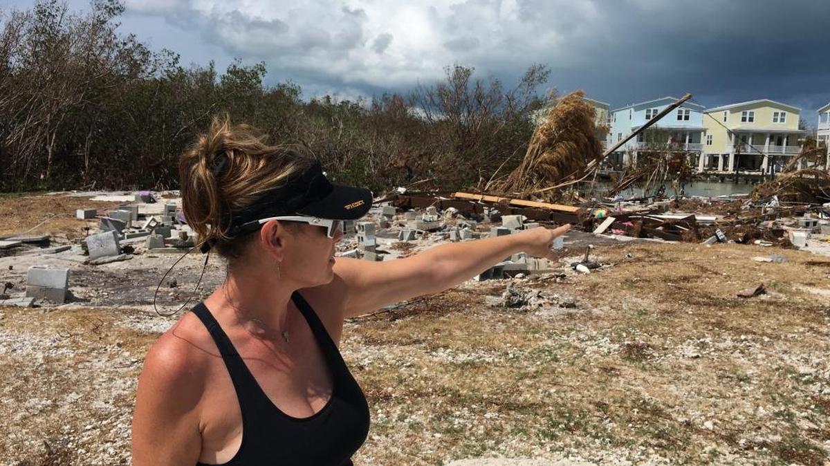 Nikki Holden points to piles of debris left behind by Hurricane Irma at what was her mother’s trailer in Trailer Ranch by the Sea in Marathon.