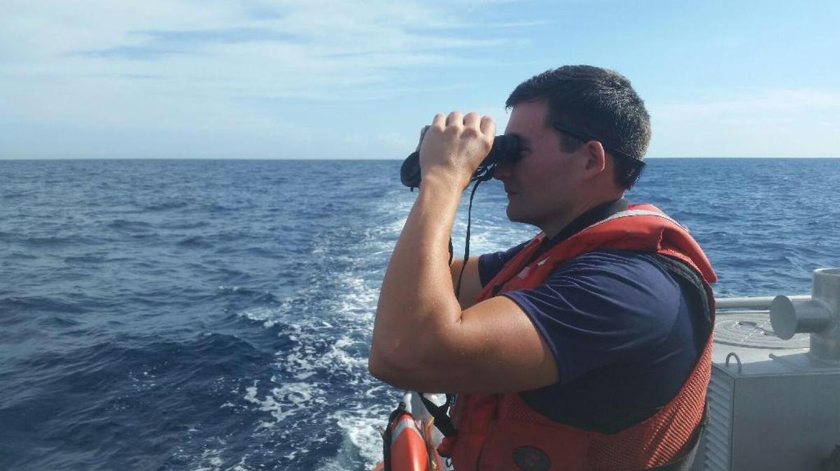 A U.S. Coast Guard sailor searches for Canadian filmmaker Rob Stewart in early February.