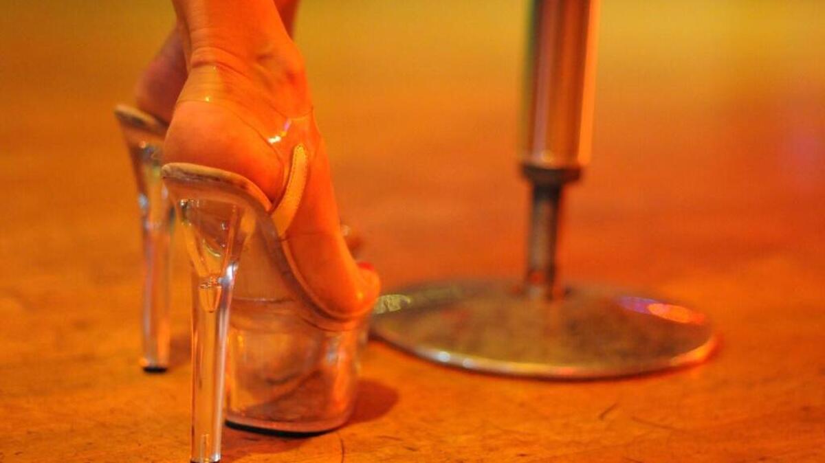 A pair of ‘stripper heels’ wait next to a pole at a South Florida strip club. A Key West club has settled a lawsuit with strippers over wages.