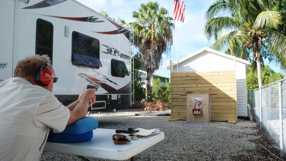 Doug Varrieur shoots at a target he built at his canal front home in a residential neighborhood on Big Pine Key in the Florida Keys.