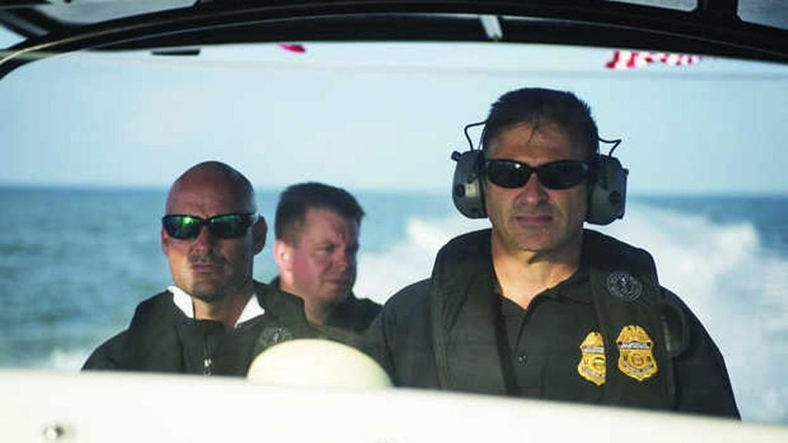 Three interdiction agents with U.S. Customs Air and Marine Operations cruise in their 40-foot Midnight Express center console looking for signs of maritime smuggling.