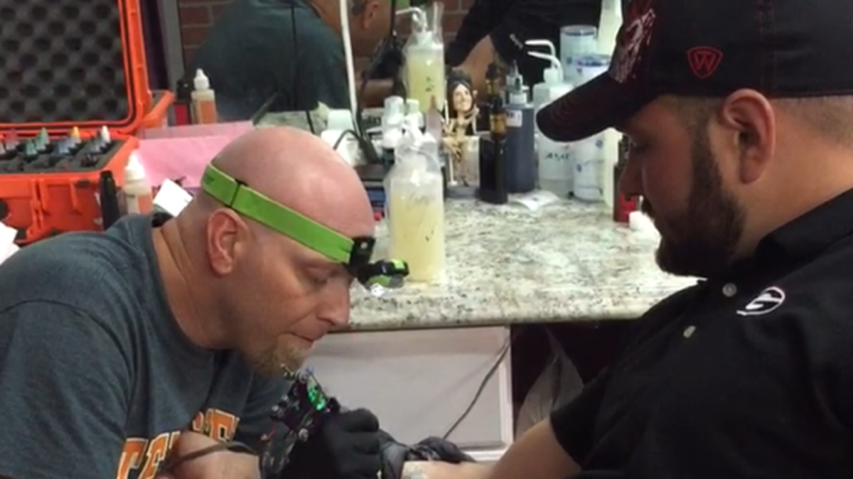 Jason Covington works on a tattoo in this photo. He gave a $200 tattoo to Villanueva Saturday night.