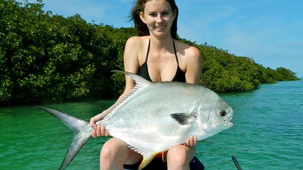 Florida Keys angler Sarah Kelly shows a permit taken on a flat off the Lower Keys before the fish was released. Conservationists seek a longer closed season on permit in South Florida.