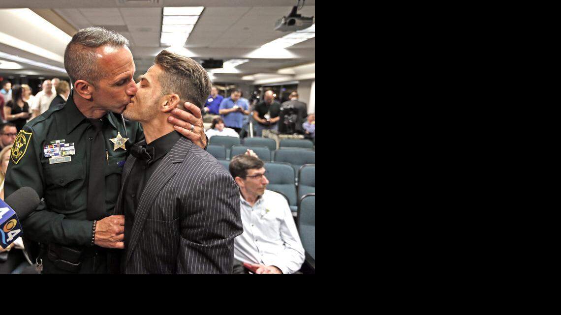 
Broward Sheriff’s Office officer David Currie and Aaron Woodard kiss after a mass wedding at the Broward County Courthouse in Fort Lauderdale.
