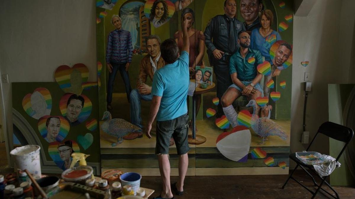 Yuriy Karabash paints a panels for his mural honoring both the victims and survivors of the Pulse tragedy. He works in an Orlando studio he shares with Michael Pilato. The mural also will include influential LGBTQ community members and other victims of mass shootings. The mural will be unveiled on the one-year anniversary.