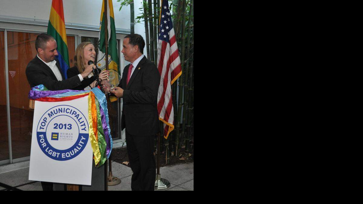
Businessman Thomas Barker and Whitney Lovell of HRC in April present Miami Beach Mayor Philip Levine with award celebrating the city’s 2013 Municipal Equality Index ranking.
