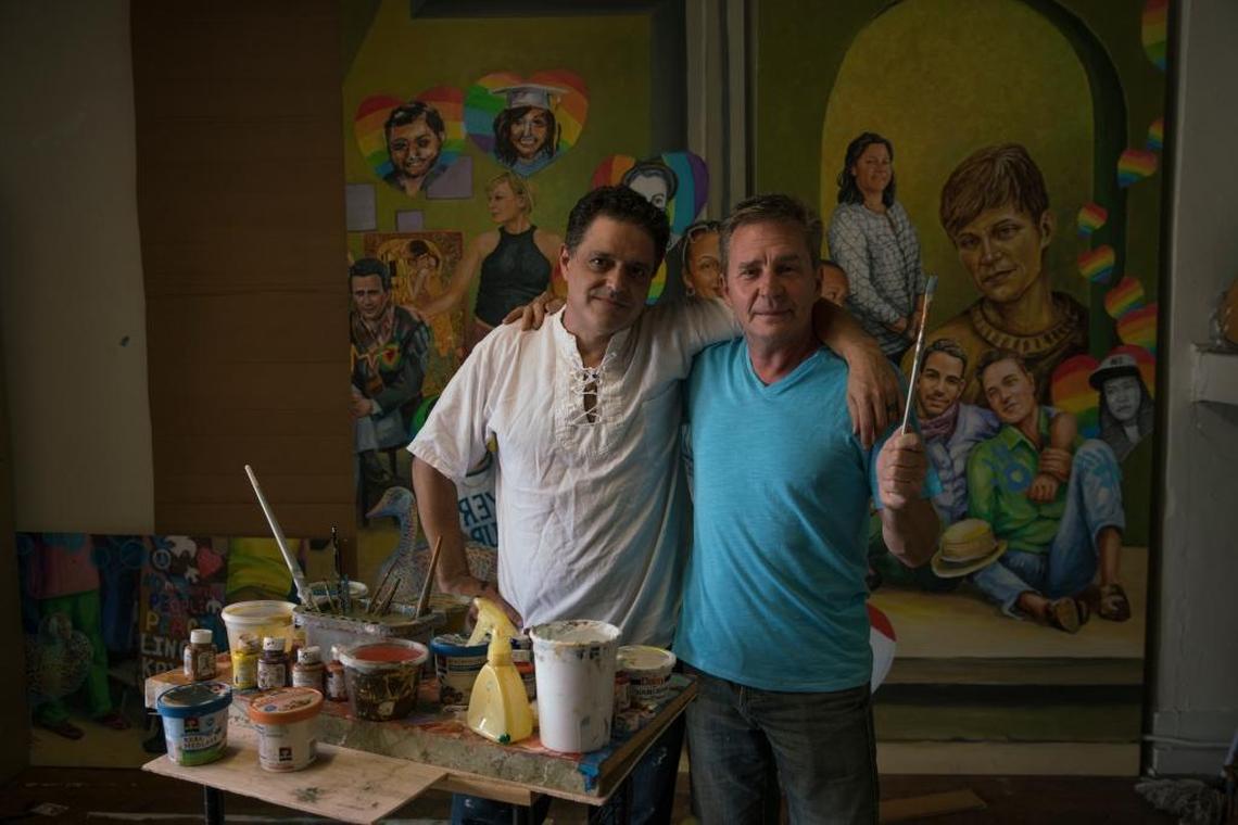 Michael Pilato, left, and Yuriy Karabash paint panels for their mural honoring both the victims and survivors of the Pulse tragedy. The work is taking place in their Orlando studio. The mural will also include influential LGBTQ community members and other victims of mass shootings. It will be unveiled on the one-year anniversary.