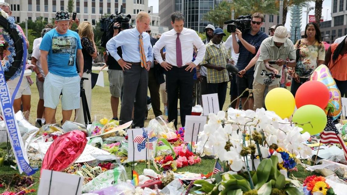 Florida Sens. Bill Nelson, a Democrat, and Marco Rubio, a Republican, visit the largest of the memorials in Orlando for the victims of the Pulse nightclub shooting, on Thursday, June 16, 2016, at the Dr. Phillips Center for the Performing Arts.
