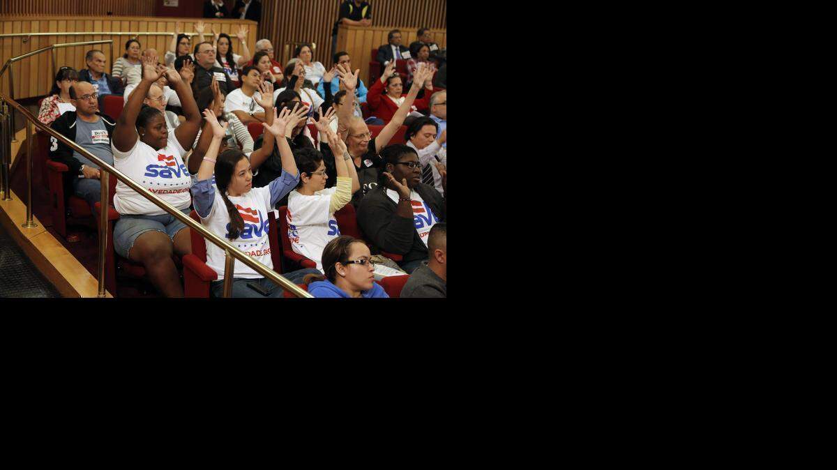 
Supporters in November raise their hands in favor of amending Miami-Dade County’s nondiscrimination law to include gender identity and expression. The ordinance passed Dec. 2. 
