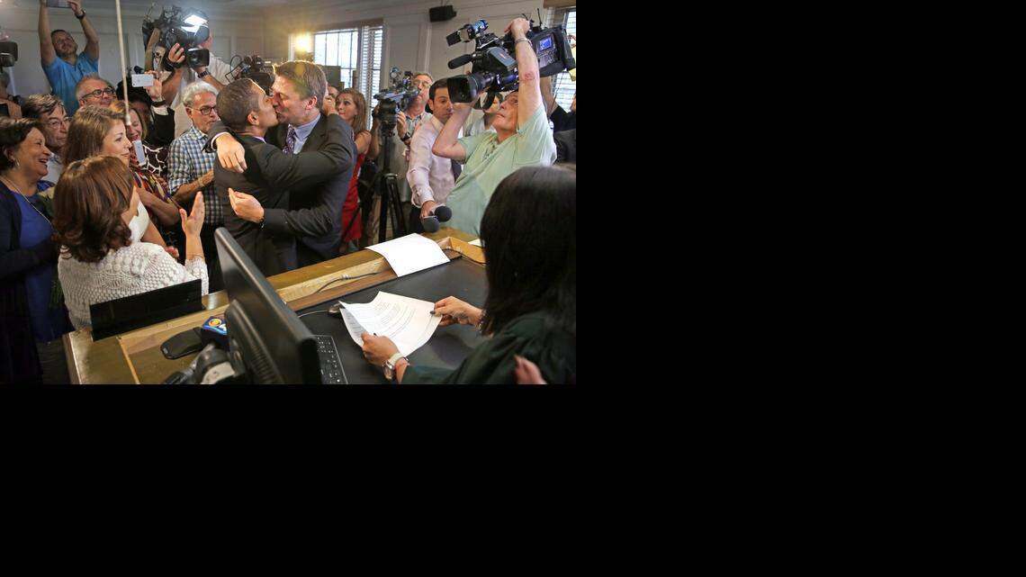 
Jeff Delmay, left, and Todd Delmay exchange vows in front of Miami-Dade Circuit Court Judge Sarah Zabel, just after she lifted her stay on Monday, Jan. 5, 2015. 
