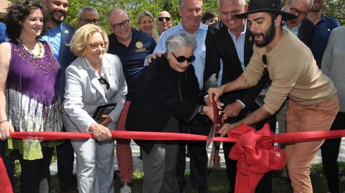 Officials and honorees cut the ribbon in front of a new LGBTQ sculpture on Saturday at Enchanted Forest Elaine Gordon Park in North Miami. From left: North Miami Councilwoman Carol Keys; SAVE Executive Director Tony Lima; retired Miami-Dade Circuit Judge Victoria Sigler; state Rep. David Richardson, D-Miami Beach; former Miami-Dade Commissioner Ruth Shack; former North Miami Mayor Kevin Burns; North Miami Councilman Scott Galvin; artist Alan Gutierrez and Miami-Dade Circuit Judge David Young. In the background are Gordon’s daughter-in-law Liebe Gadinsky and son Seth Gadinsky.