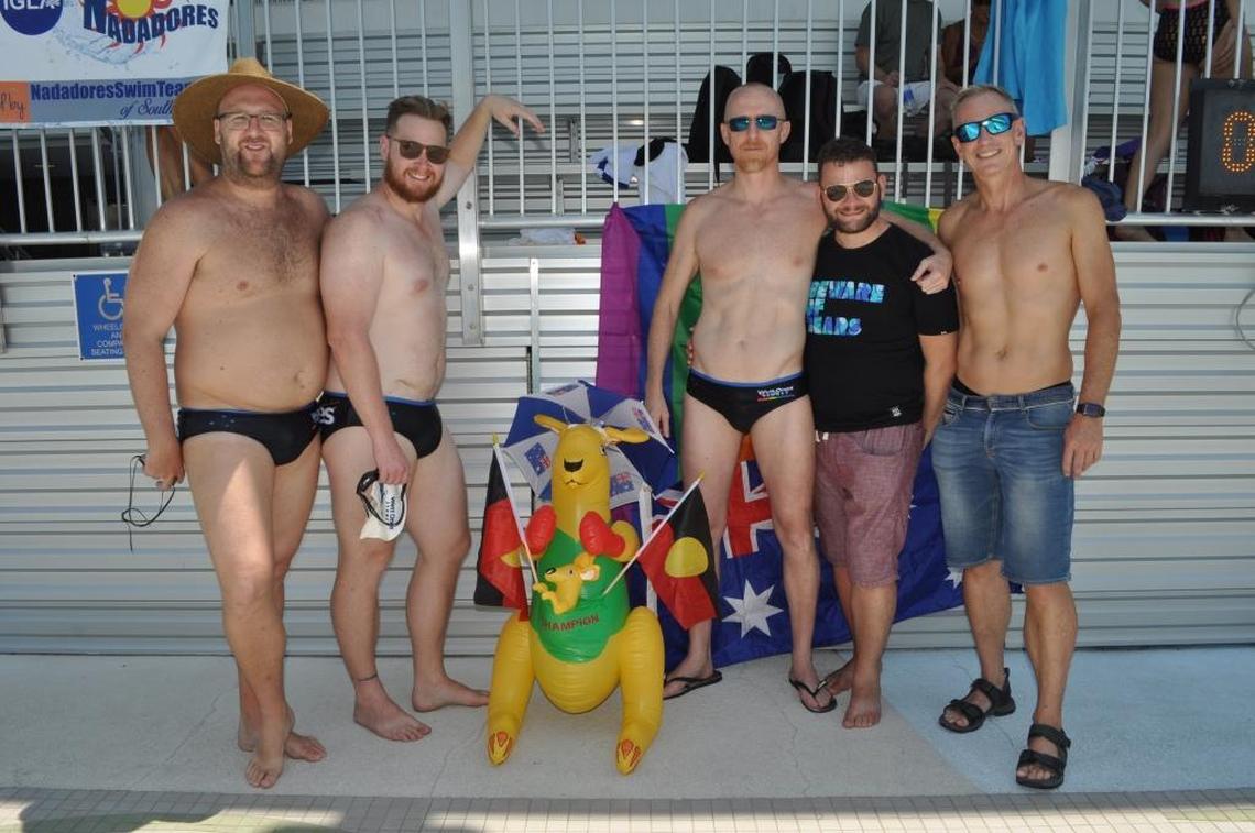 Members of the Australian aquatics team including husbands Mark Holmes, second from left, and David Helliwell, in the ‘Beware of Bears’ T-shirt. Holmes and Helliwell paid WorldOutgames Miami in advance for their room at the National Hotel. The hotel says WorldOutgames Miami didn’t pay its bill and charged the couple another $798.