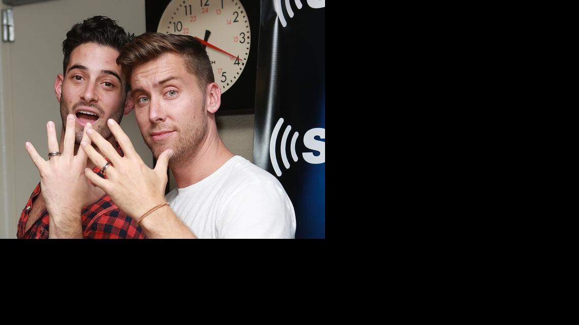
Michael Turchin, left, and Lance Bass show off their David Yurman rings in the SiriusXM studio during Bass' show ‘Dirty Pop with Lance Bass’ as they announce their engagement on Sept. 18, 2013.
