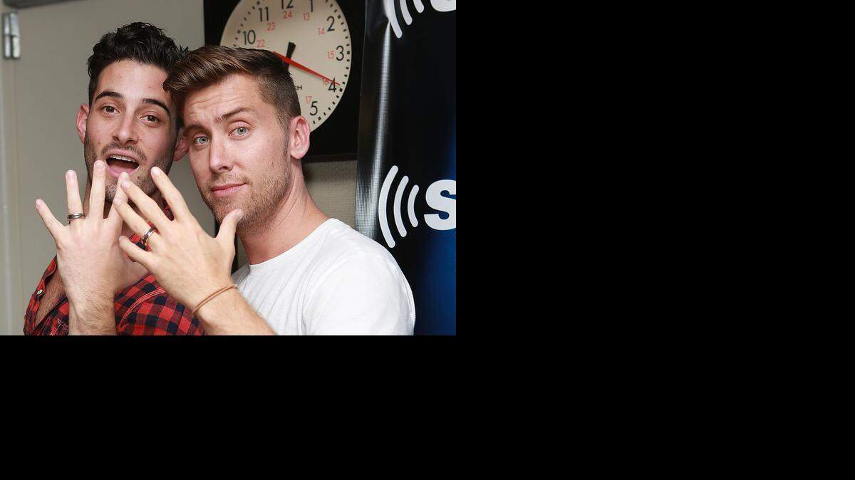
Michael Turchin, left, and Lance Bass show off their David Yurman rings in the SiriusXM studio during Bass' show ‘Dirty Pop with Lance Bass’ as they announce their engagement on Sept. 18, 2013.
