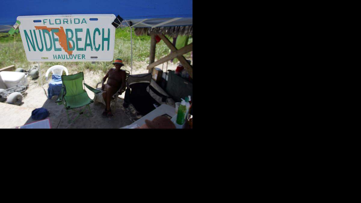 
A man sits at the concession stand on a stretch of Haulover Beach open to nude bathers.
