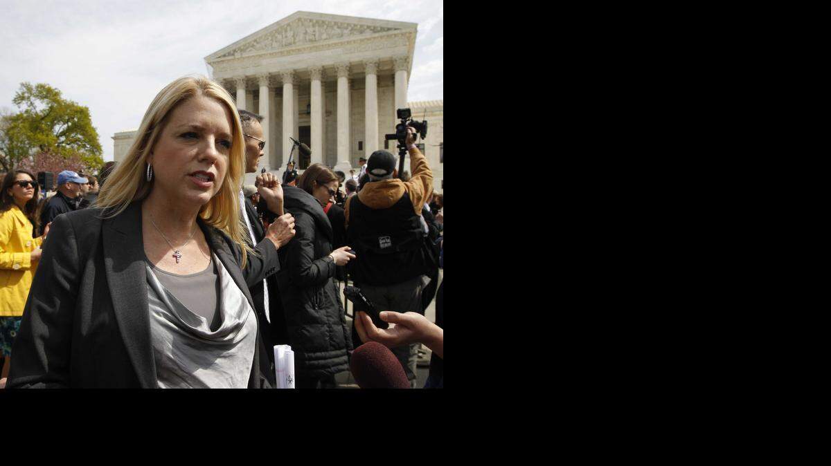 
Florida Attorney General Pam Bondi speaks to reporters in front of the Supreme Court in Washington in 2012.
