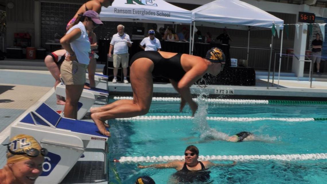 Jax Cole, 36, a World OutGames Miami competitor from Long Beach, California, dives into the pool Sunday at Ransom Everglades School in Coconut Grove.