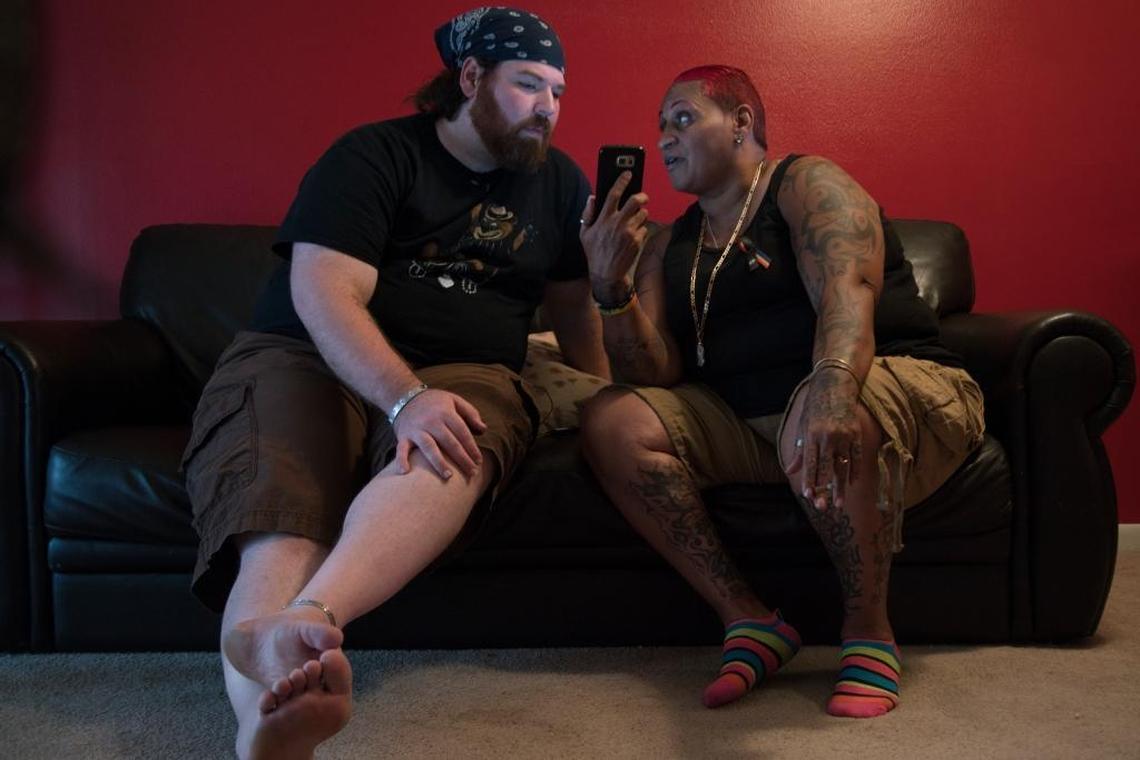 Christopher Hansen and India Godman watch videos on Godman’s phone at her apartment in Orlando. Godman was also at Pulse the night of the massacre.