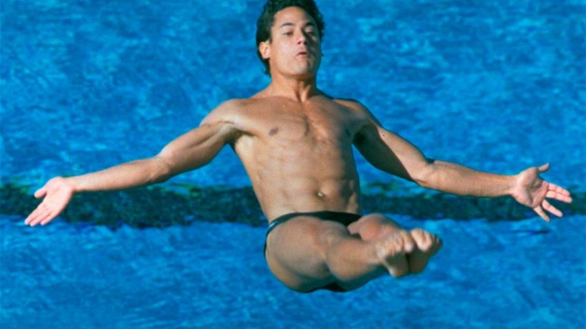 FILE - In this Aug. 7, 1984, file photo, U.S. diver Greg Louganis of Mission Viejo, Calif. does a back 2-1/2 somersault from the tuck position during springboard preliminaries in the Summer Olympics in Los Angeles.