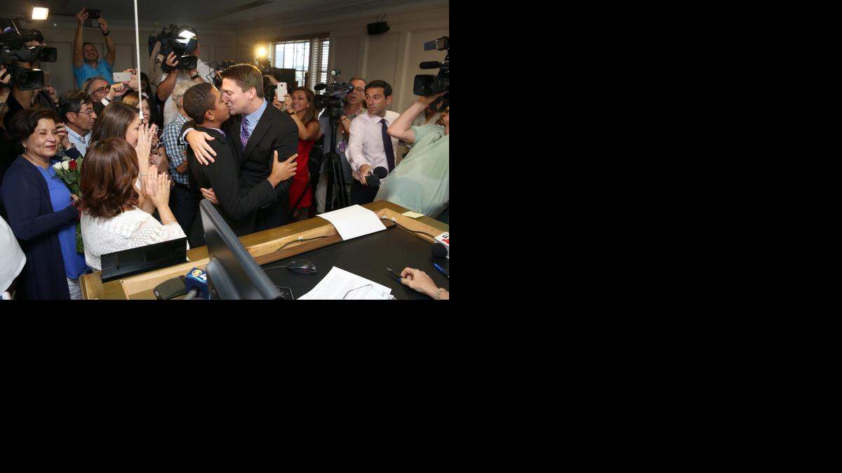 
As Karla Arguello and Catherina Pareto look on, Jeff Delmay (left) and Todd Delmay exchange vows in front of Miami-Dade Circuit Judge Sarah Zabel on Monday afternoon, Jan. 5, 2015. Zabel lifted a stay on Florida’s same-sex marriage ban, allowing couples to marry in Miami-Dade County.
