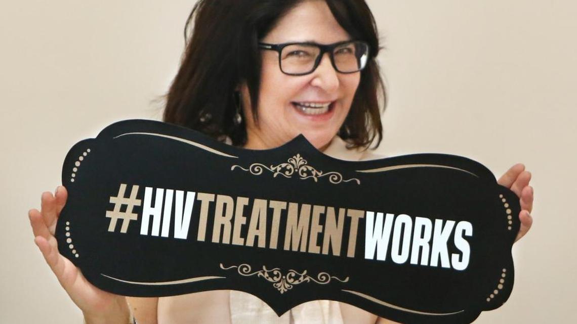 Mariana Jacobo, a volunteer, holds a sign during Pridelines' Bridging Generations Through Dialogue conference on Saturday, Sept. 24, 2016 in Miami. The free conference took an intergenerational approach to addressing HIV's impact on the community.