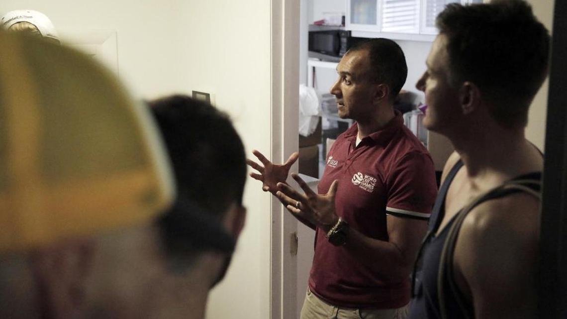 Ivan Cano, (second from right), CEO of the organization that produced the OutGames, speaks to athletes who are looking for an explanation at the offices of the World OutGames in Miami Beach on May 26.