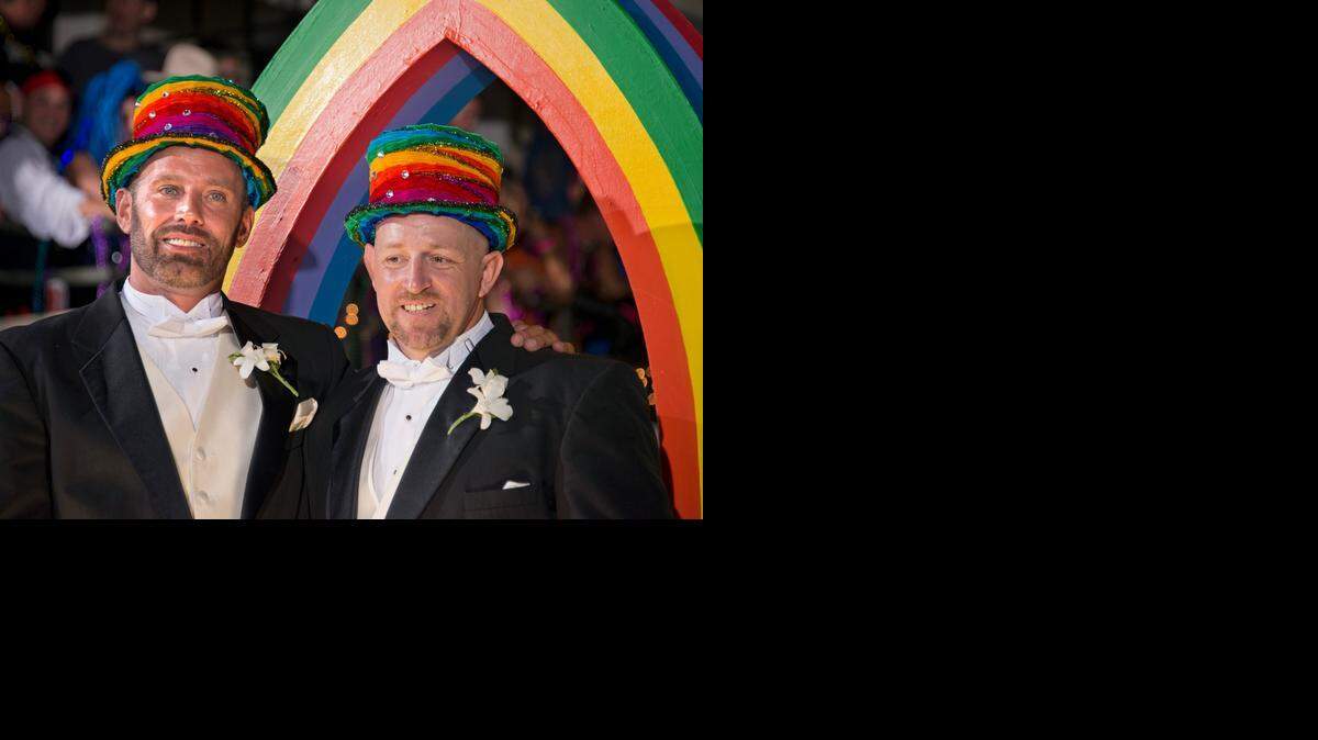 
Aaron Huntsman, left, and William Lee Jones, right, ride the grand marshals' float during the 3 Wishes.com Fantasy Fest Parade Saturday, Oct. 25, 2014, in Key West, Fla. Jones and Huntsman were selected to preside over the parade because of their contributions to lead the Florida Keys and Florida into same-sex marriage equality. The couple won a ruling from a Monroe County judge overturning Florida’s same-sex marriage ban, but are not wed yet because Florida Attorney General Pam Bondi appealed.
