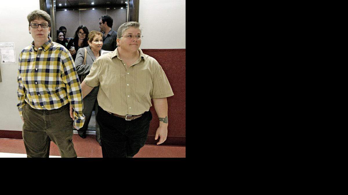 
Heather Brassner and new partner Jennifer Feagin at the Broward County Courthouse after Circuit Judge Dale Cohen initially ruled in August to recognize Brassner's Vermont civil union and grant her a divorce from her estranged former partner. Cohen later vacated his own ruling after learning Florida Attorney General Pam Bondi’s office had not been properly notified of the case.
