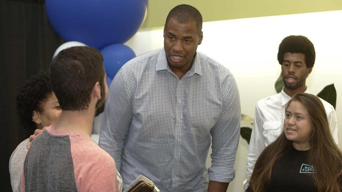 Students Daniel Camacho, left, and Katherine Granados talk to gay former NBA player Jason Collins, center, at Miami Dade College North Campus on Wednesday, Sept. 28, 2016.