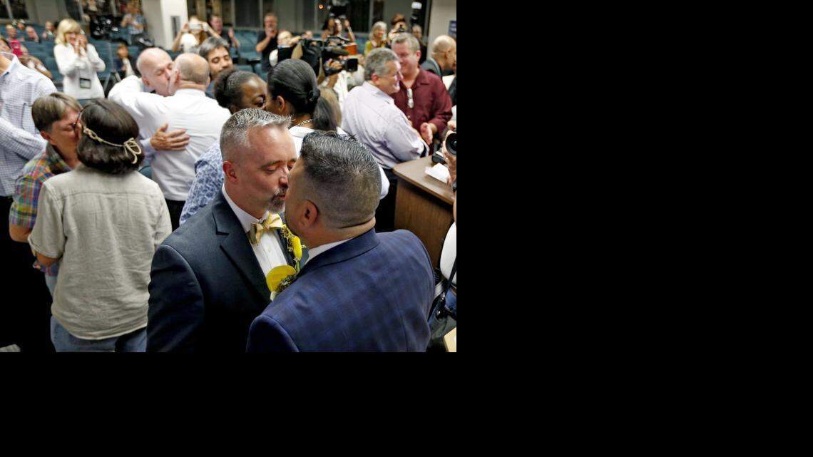 
Rich Matthews and Carlos Noda kiss during a mass wedding at the Broward County Courthouse in Fort Lauderdale early Jan. 6, 2014.
