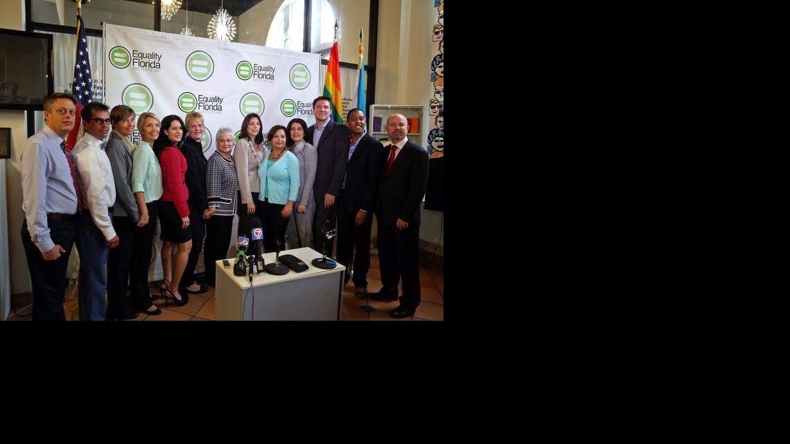 
From left, partners Don Price Johnston and Jorge Isaias Diaz; partners Melanie and Vanessa Alenier; attorney Cristina Alonso of Carlton Fields Jorden Burt; partners Pamela Faerber and Summer Greene; partners Catherine Pareto and Karla Arguello; attorney Elizabeth Schwartz; partners Todd and Jeff Delmay; and NCLR Legal Director Shannon Minter at a Jan. 21, 2014, news conference announcing the first gay-marriage lawsuit in Florida.
