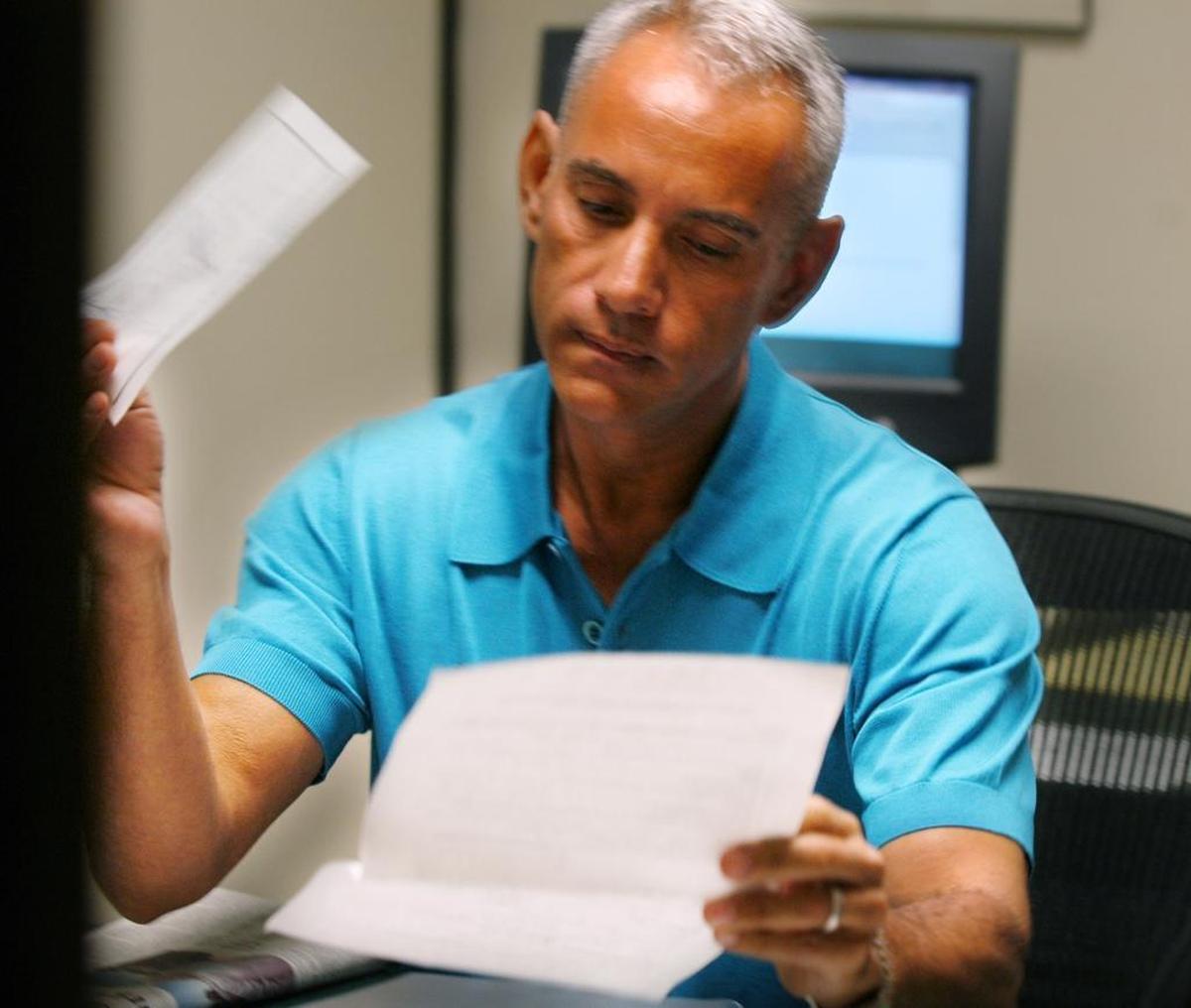In 2004, Winter Party co-founder Dennis Leyva reviews paperwork as he became the first applicant for Miami Beach’s then-new domestic partnership registry.
