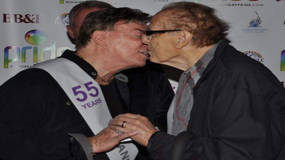 
Frank Petrole, left, and Marc Rudick, together for 55 years, kiss at their wedding on Feb. 19 conducted during a Miami Beach Gay Pride fundraiser at BB&T Bank South Beach branch.
