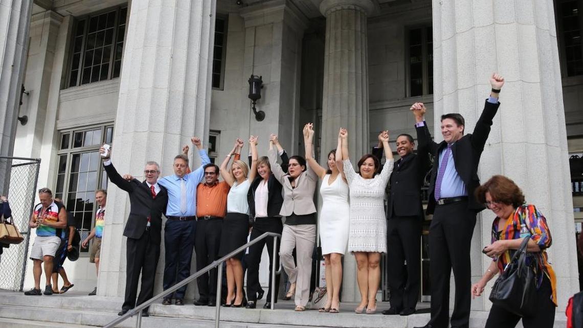 Attorney Elizabeth Schwartz, center, joins hands with plaintiffs in the gay marriage ruling on the Miami-Dade County courthouse steps after the ban was successfully lifted on Jan. 5, 2015, by Circuit Judge Sarah Zabel.
