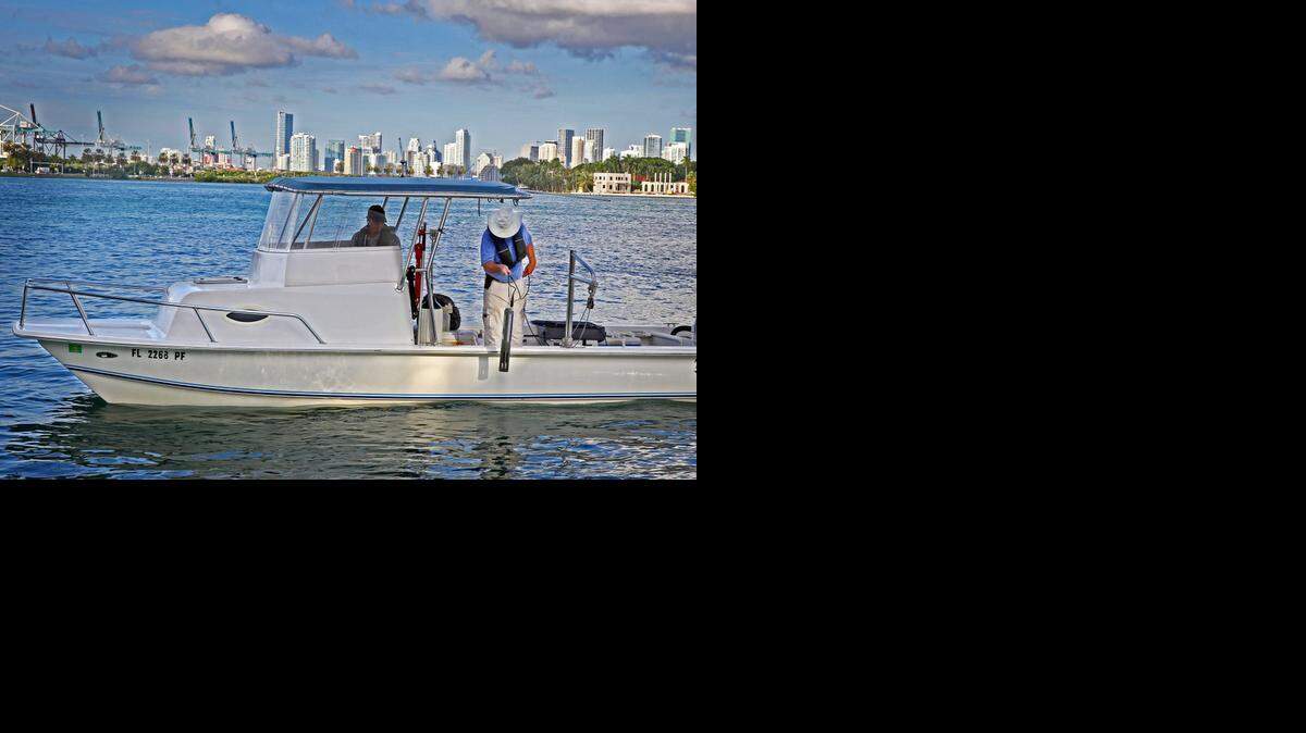 
Marine biologists Jeff Absten, right, and Jim Duquesnel gather water samples during the King Tide in Biscayne Bay with a Data Sonde in October. Water samples showed elevated levels of pollution in the bay linked to stormwater pumped from Miami Beach during the high tide.
