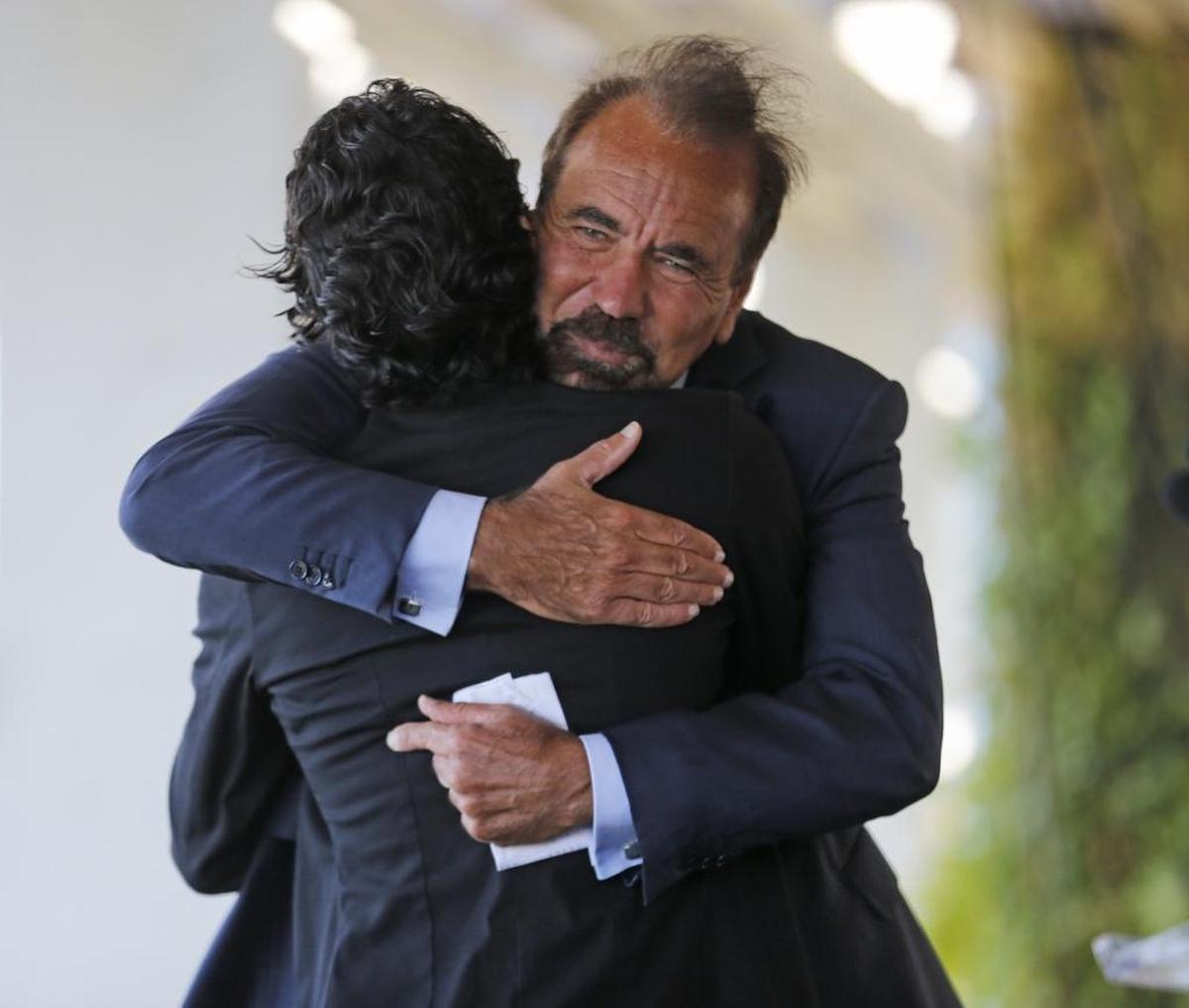 Jorge Pérez hugs Marc Anthony after it was announced that Anthony will be the music star of El Clásico, an upcoming soccer match between Real Madrid and FC Barcelona at Hard Rock Stadium.