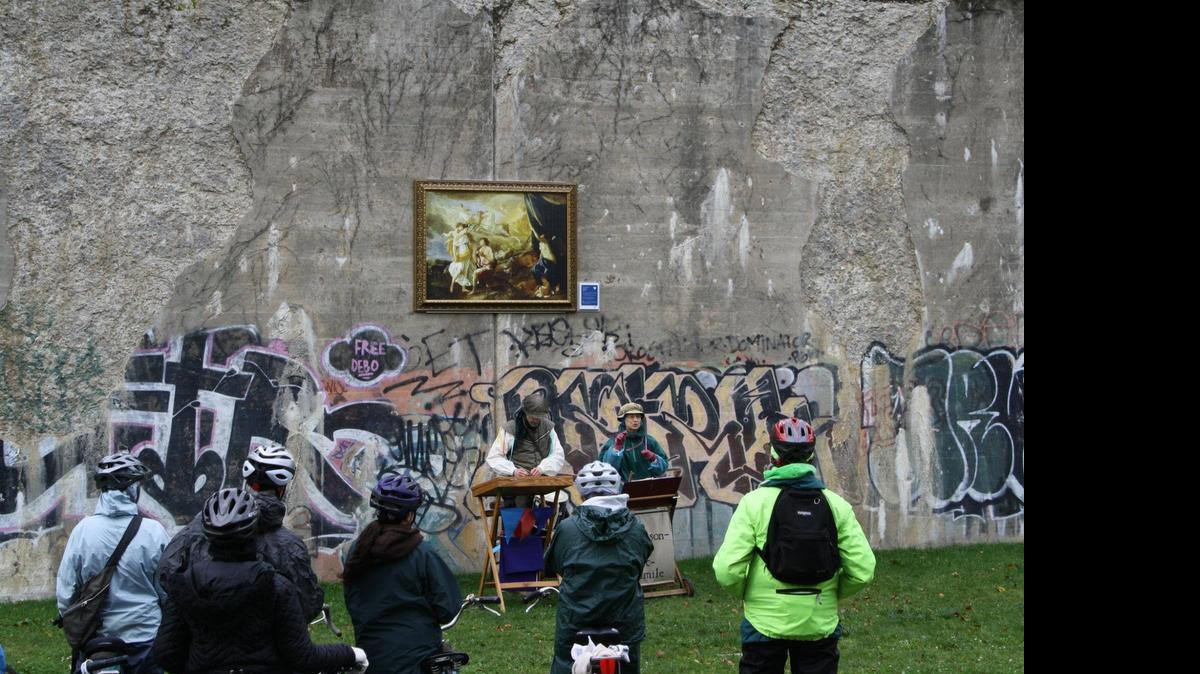 
A group of bike riders take in a up musical performance in front of an Inside|Out reproduction of “Selene and Endymion” by Nicolas Poussin in Detroit’s Dequindre Cut greenway.
