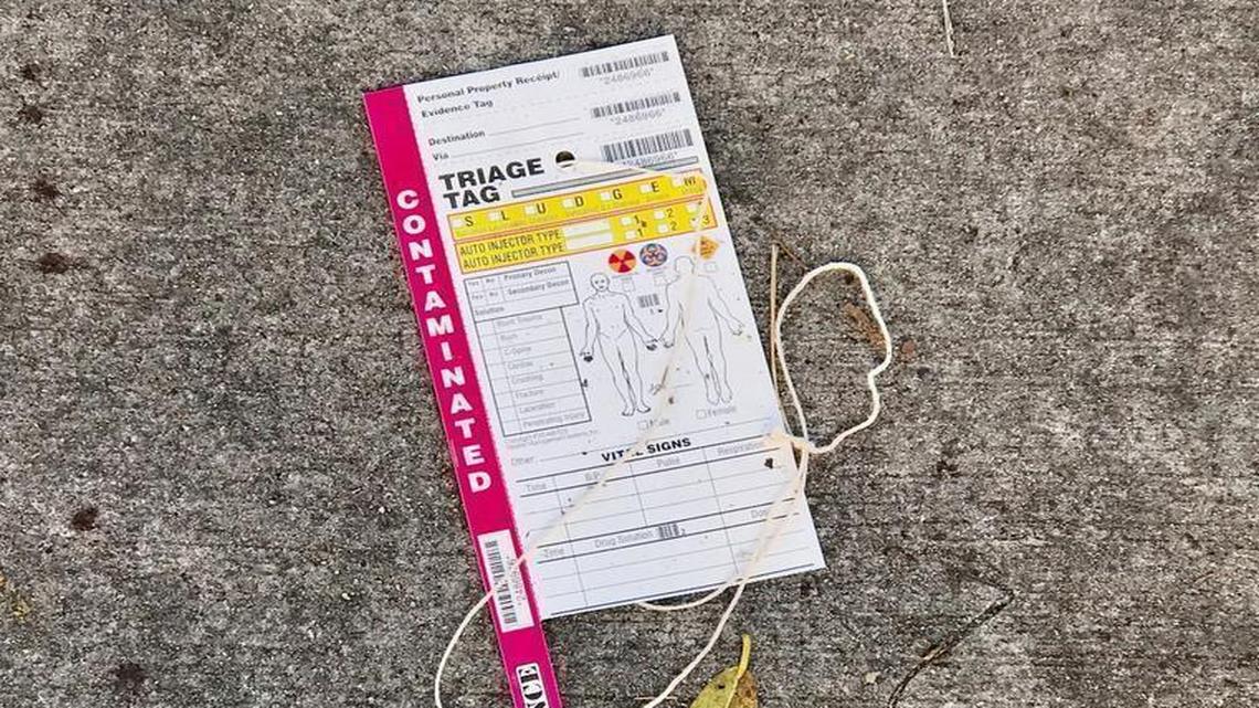 An unused triage tag, which are used to indicate the severity of injuries when multiple people are hurt, remained on the sidewalk Monday after a New Year’s Day shooting left seven injured in Northwest Miami-Dade.