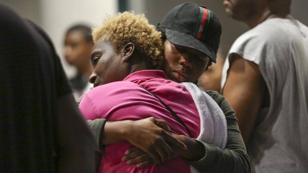 Family and friends gathered outside Ryder Trauma Center Sunday, Aug. 28, 2016, after news spread that an 8-year-old girl and her 32-year-old father were shot outside a Northwest Miami-Dade home.