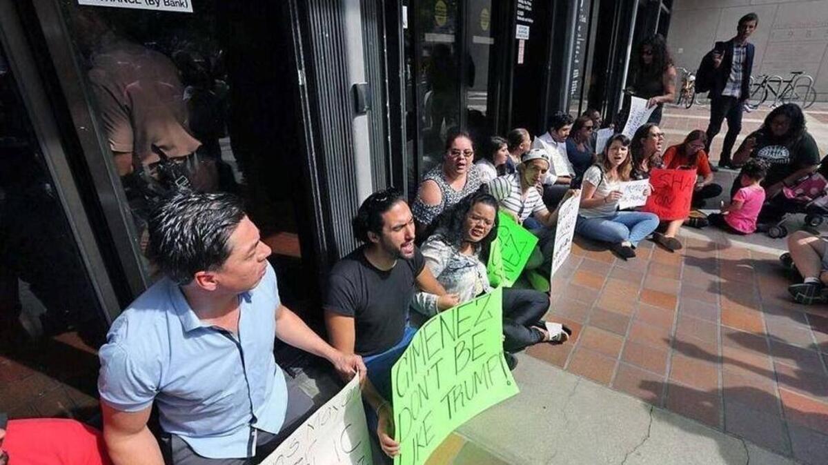 Protesters were locked outside Miami-Dade County Hall as they demonstrated against the mayor’s immigration-detention policy in January.