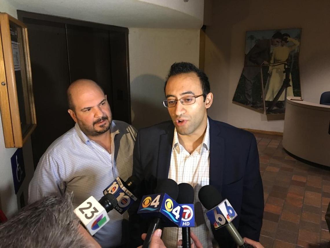 Political consultant Christian Ulvert, left, and Uber Miami chief Kasra Moshkani address reporters in Miami-Dade’s County Hall in 2016.