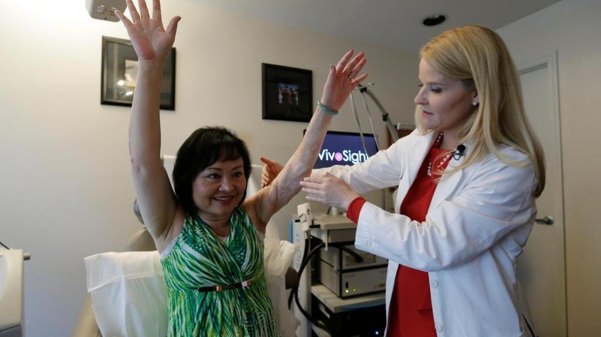 Dr. Jill Waibel examines Kim Phuc before the first of several laser treatments to reduce pain and the appearance of burn scars in her back and left arm in Miami. Phuc was injured by a napalm bomb in Vietnam 40 years ago.