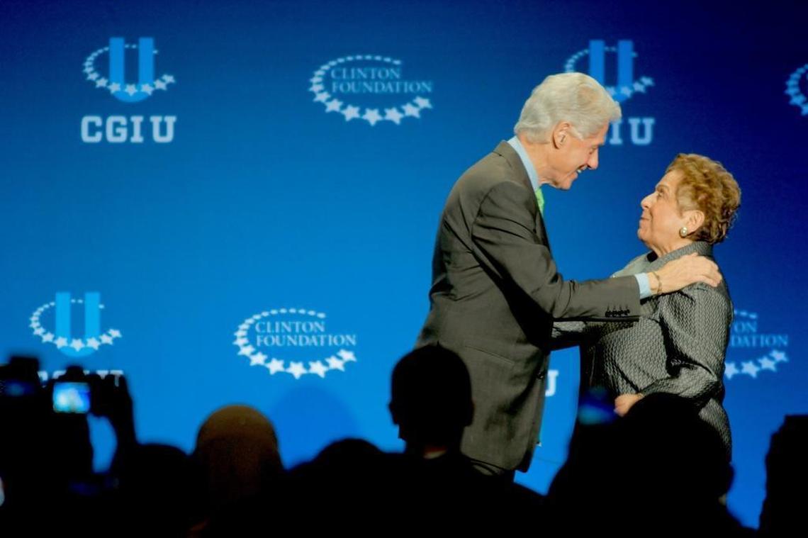 President Bill Clinton, left, hugs former University of Miami President Donna Shalala.