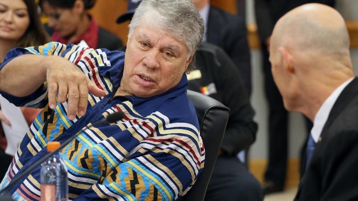 James Billy, chairman of the Seminole Tribe of Florida, left, leans to speak to Governor Rick Scott, right, during the governor’s visit to the tribe’s headquarters in February. Billie was ousted as chairman of the tribe on Wednesday.