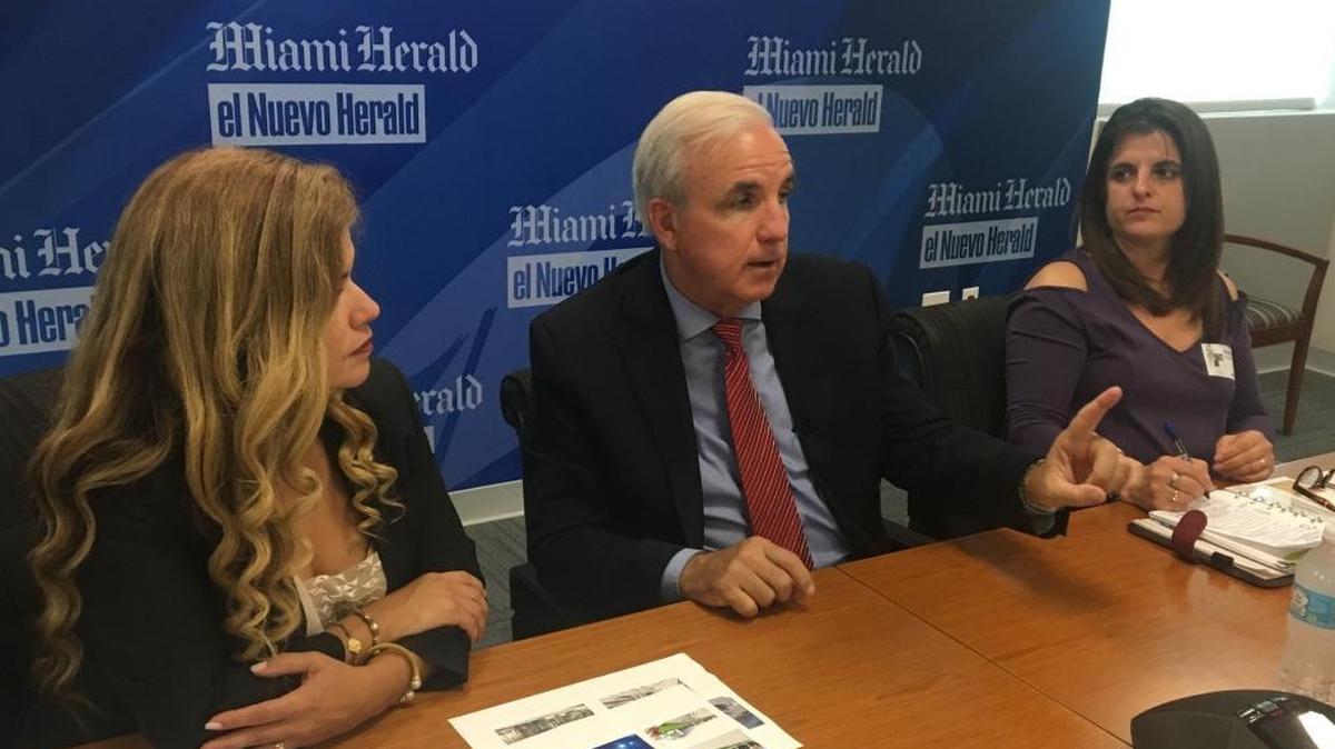 Miami-Dade Mayor Carlos Gimenez flanked by his two deputies in the center of a budget fight over transit cuts: Alice Bravo, left, the county’s transportation director, and Jennifer Moon, right, the county’s budget director. The photo was taken during a meeting with the Miami Herald Editorial Board in July.